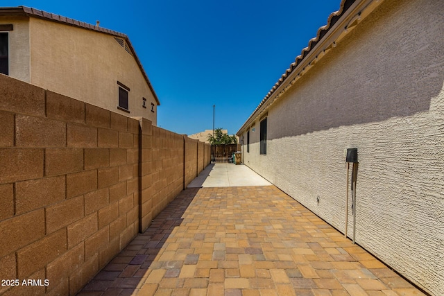 18669 W Vista Norte St, Goodyear, AZ 85338 - view of home's exterior featuring a fenced backyard, stucco siding, and a patio area