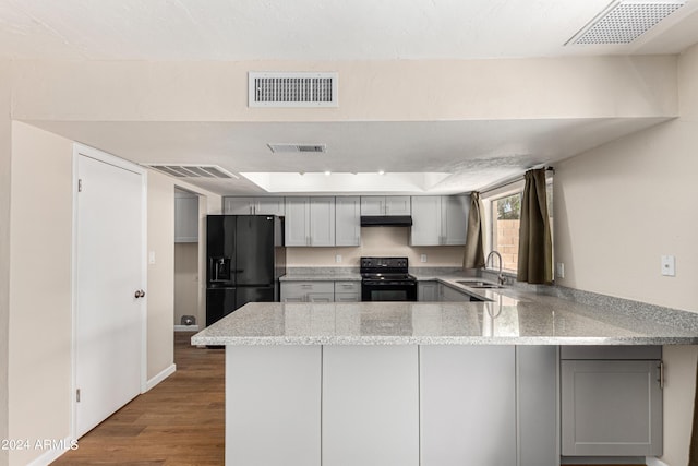 kitchen with gray cabinetry, sink, black appliances, and kitchen peninsula