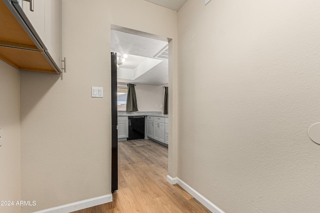 hallway with light hardwood / wood-style floors