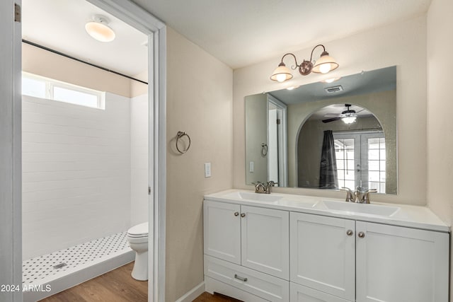 bathroom with vanity, wood-type flooring, french doors, toilet, and walk in shower