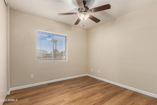 empty room featuring ceiling fan and hardwood / wood-style floors