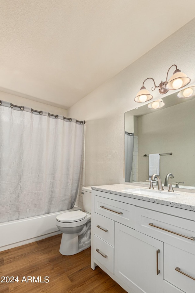 full bathroom with hardwood / wood-style flooring, vanity, toilet, and shower / bath combination with curtain