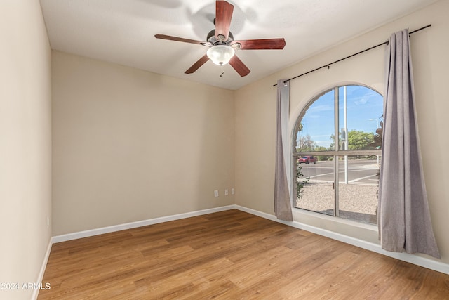 empty room featuring light hardwood / wood-style flooring and ceiling fan