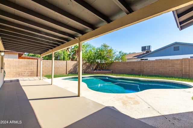 view of swimming pool featuring a patio area and central air condition unit