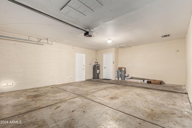 garage with a garage door opener and water heater