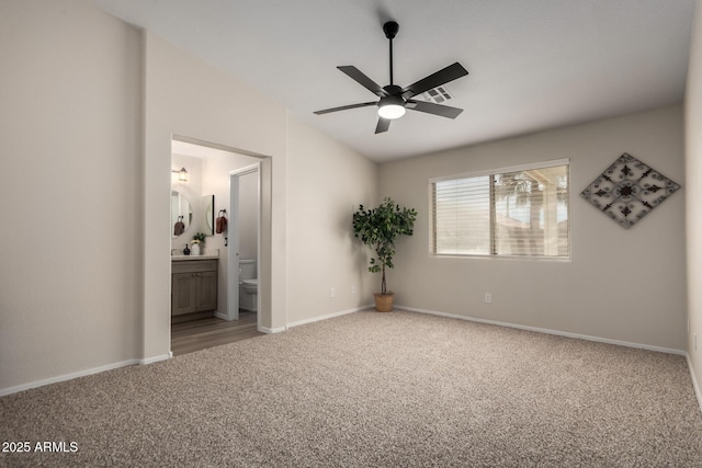 unfurnished bedroom with baseboards, carpet, vaulted ceiling, and visible vents