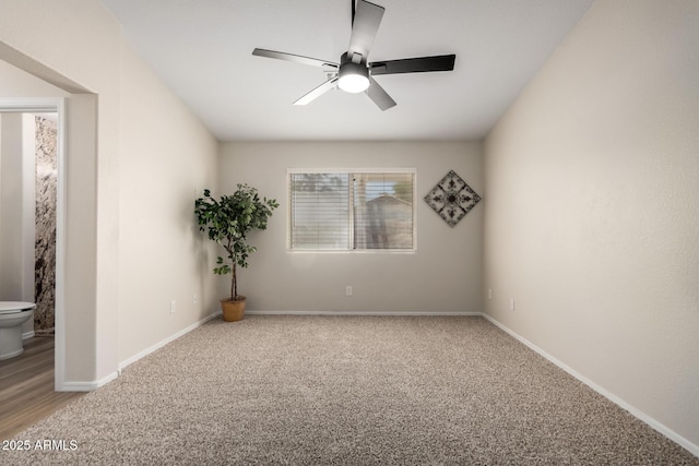 unfurnished room with a ceiling fan, baseboards, and light carpet