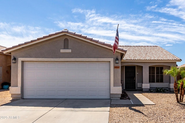 ranch-style home with an attached garage, a tile roof, and stucco siding