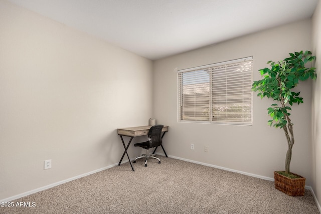 unfurnished office featuring carpet floors and baseboards