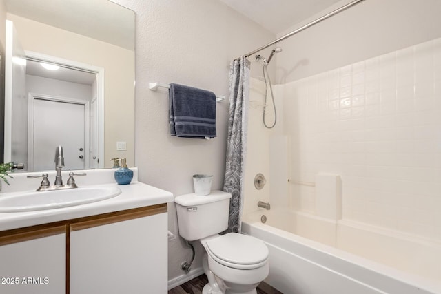 bathroom featuring vanity, shower / bath combo, and toilet
