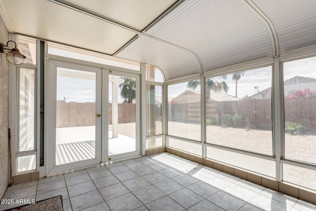 unfurnished sunroom featuring plenty of natural light and french doors