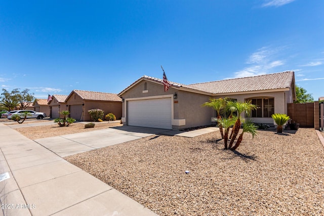 ranch-style house featuring a garage, stucco siding, concrete driveway, and a tiled roof