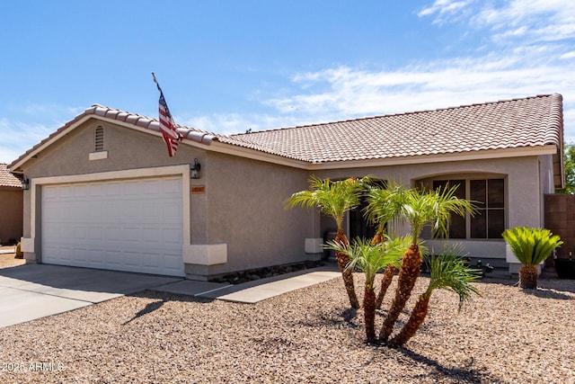 ranch-style house featuring stucco siding, an attached garage, driveway, and a tiled roof
