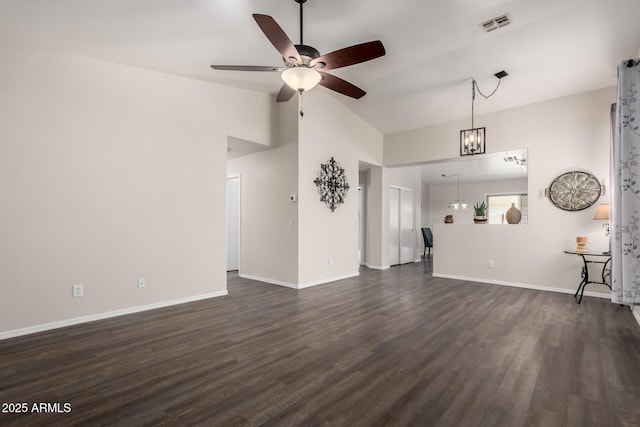 unfurnished living room with ceiling fan with notable chandelier, baseboards, lofted ceiling, visible vents, and dark wood-style floors
