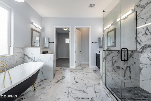 bathroom with plus walk in shower, vanity, and a wealth of natural light