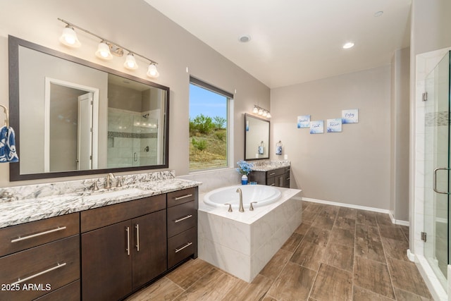 bathroom with vanity and separate shower and tub