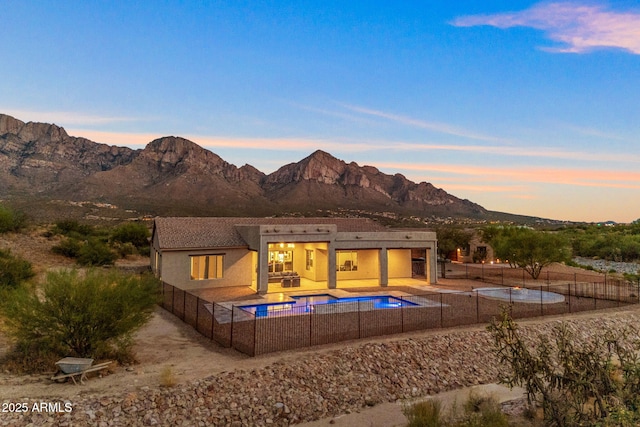 exterior space with a mountain view and a patio area