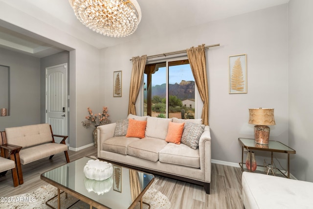 living room featuring hardwood / wood-style floors, a mountain view, and a chandelier