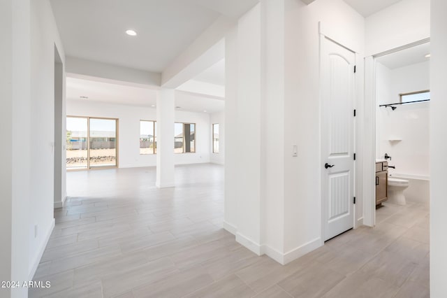 corridor with recessed lighting and baseboards