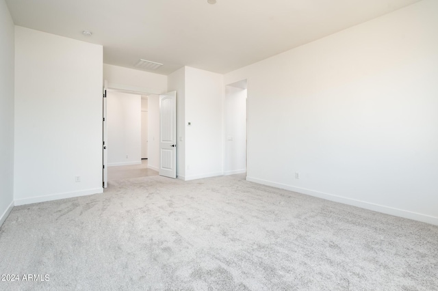 carpeted empty room with baseboards