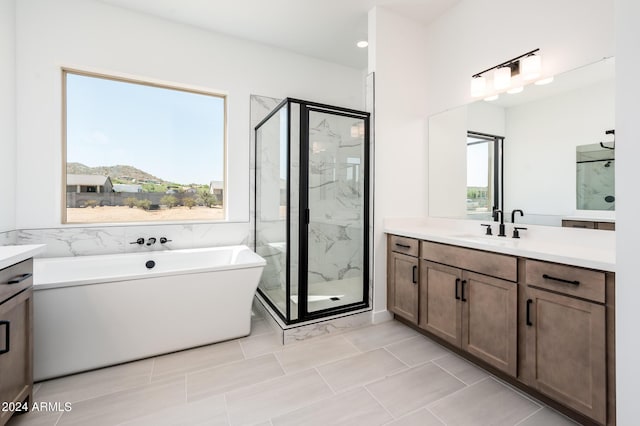 bathroom with vanity, a marble finish shower, and a freestanding bath