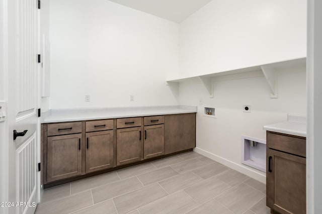 laundry area with electric dryer hookup, cabinet space, and washer hookup