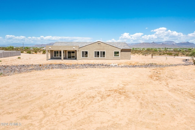 view of front of property with a mountain view and stucco siding