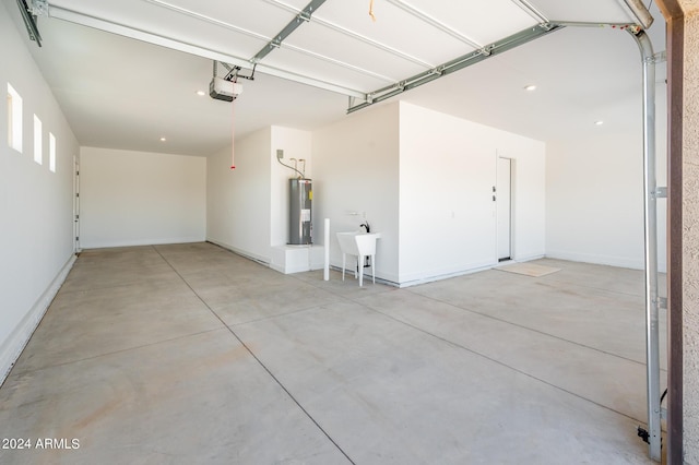 garage with electric water heater, a garage door opener, and a sink