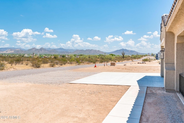 view of yard with a mountain view and a patio area