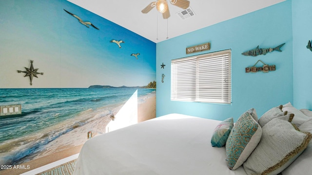 bedroom featuring a water view, ceiling fan, and visible vents