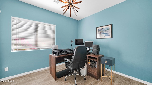 home office featuring visible vents, baseboards, and wood finished floors