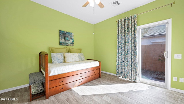 bedroom with baseboards, ceiling fan, visible vents, and wood tiled floor