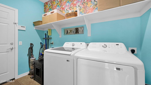 laundry room featuring baseboards, laundry area, separate washer and dryer, and tile patterned floors