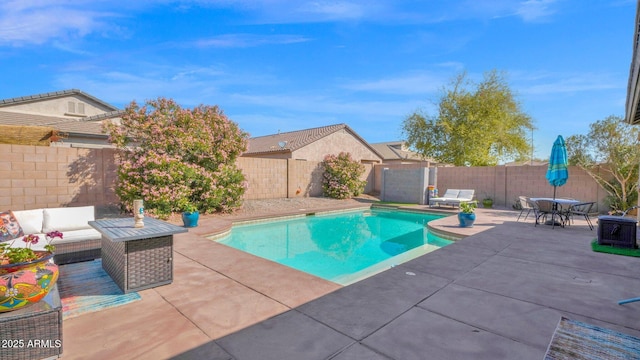 view of swimming pool with a patio, outdoor dining area, a fenced backyard, an outdoor hangout area, and a fenced in pool