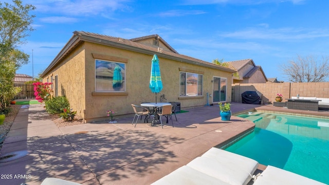 view of swimming pool with outdoor lounge area, a patio area, a fenced backyard, and a fenced in pool