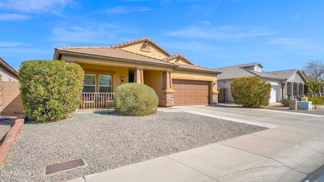 ranch-style home with a garage, concrete driveway, stone siding, a tile roof, and stucco siding