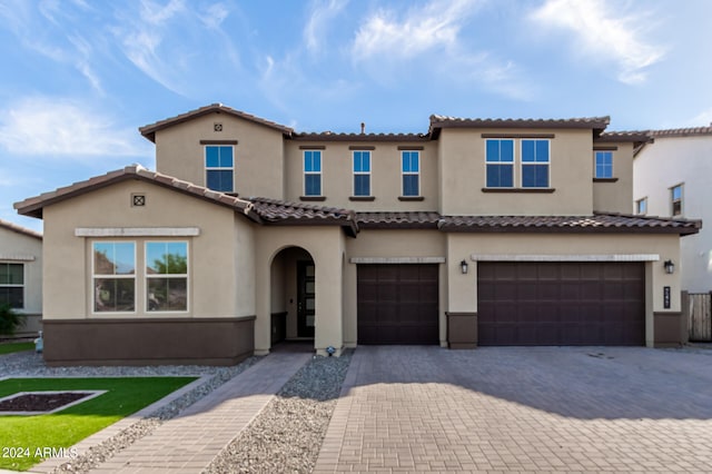 mediterranean / spanish-style house featuring a garage