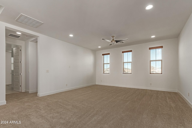 unfurnished room with ceiling fan and light colored carpet