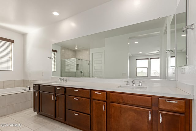 bathroom featuring vanity, shower with separate bathtub, and tile patterned floors