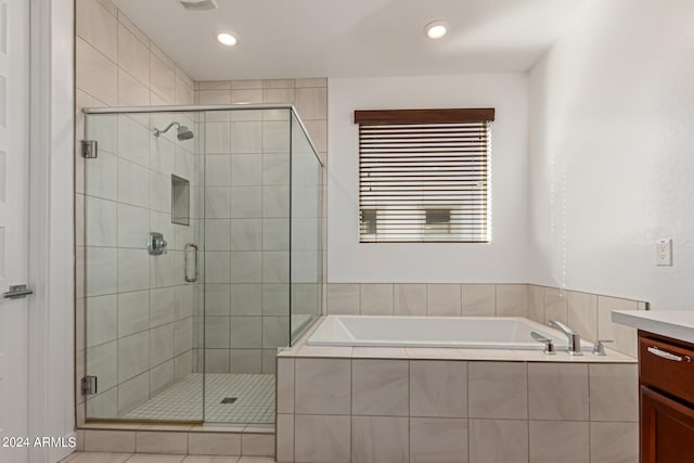 bathroom with vanity and separate shower and tub