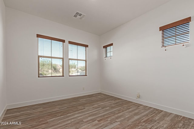 spare room with wood-type flooring