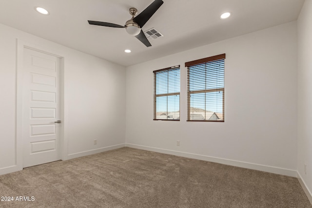 spare room with light carpet and ceiling fan