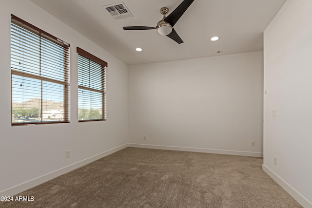 empty room with carpet flooring and ceiling fan