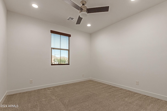 spare room featuring carpet and ceiling fan