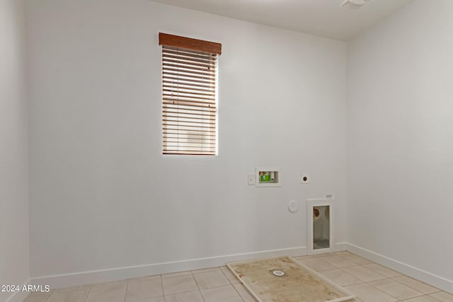 washroom featuring hookup for a gas dryer, hookup for an electric dryer, hookup for a washing machine, and light tile patterned floors