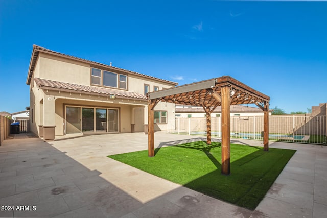 back of property featuring a yard, a patio area, and a pergola