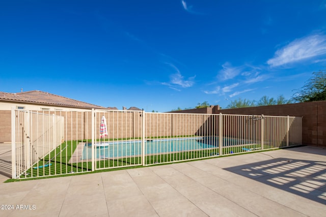 view of patio / terrace with a fenced in pool