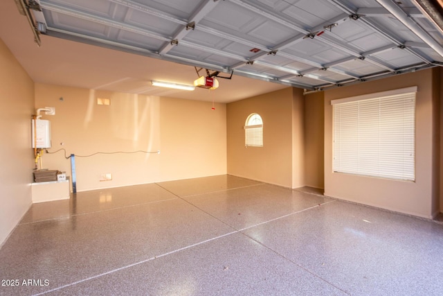 garage featuring water heater and a garage door opener