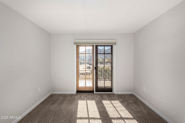 empty room featuring french doors and dark carpet