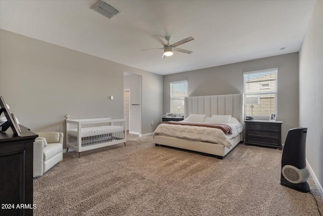 bedroom with light carpet, ceiling fan, baseboards, and visible vents